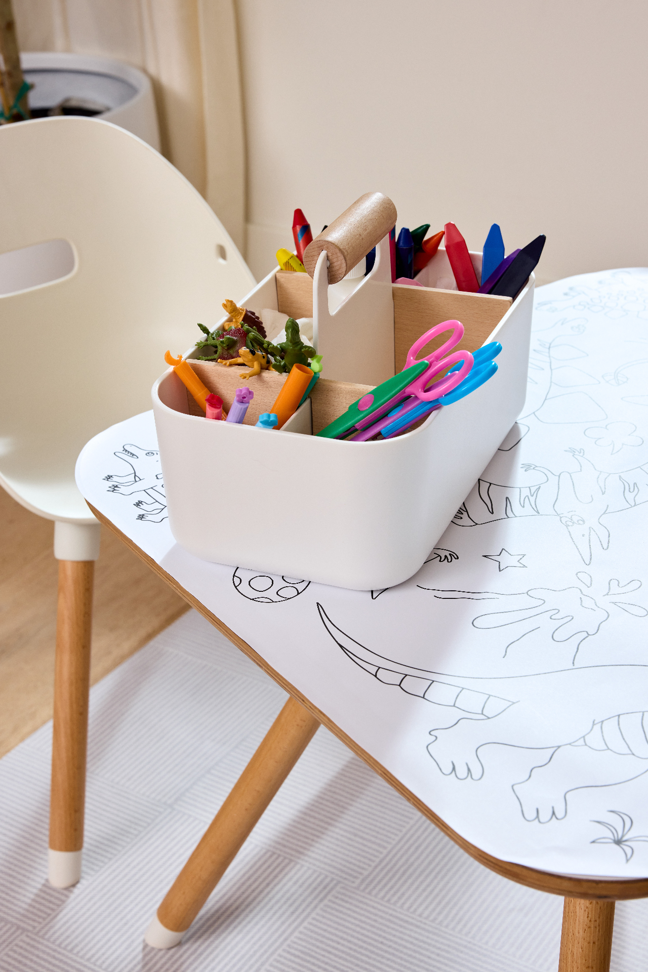 Lalo Play Caddy filled with crayons, scissors, and toys on a Play Table